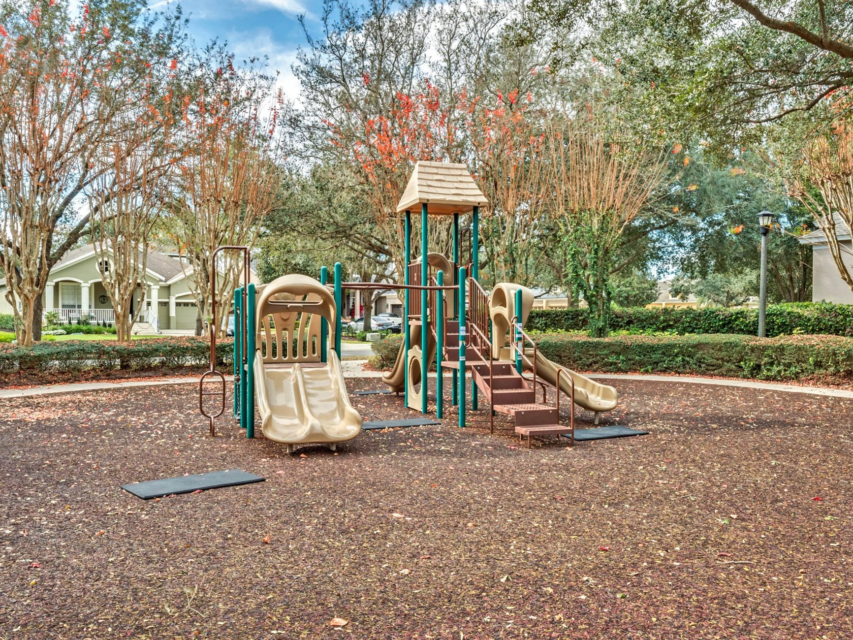 Children’s playground surrounded by mature trees at Keene’s Pointe