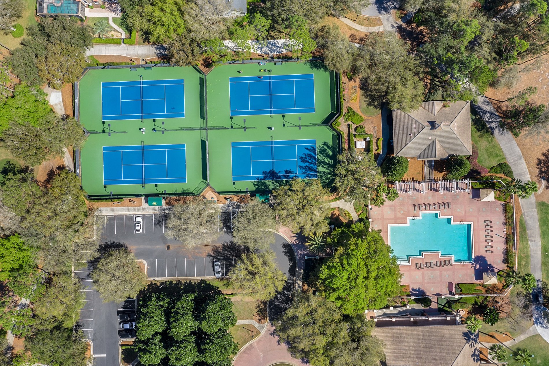 Aerial view of tennis courts and outdoor pool at Keene’s Pointe
